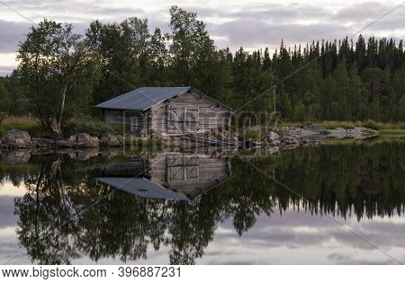 Boathouse On Lake Ostersjon Under A Beautiful Evening Sky Close To The Swedish Village Tannas