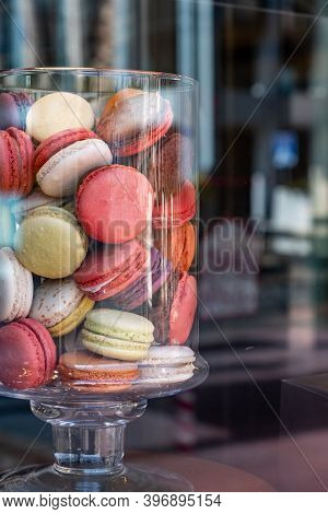 Macarons In A Glass Jar. French Colorful Delicate Sweets Assortment, Vertical. Candy Store Window Di