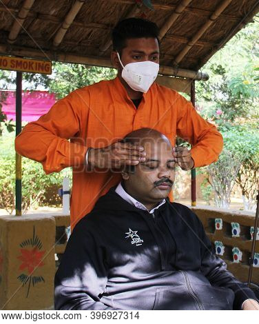Delhi - India
20th Nov 2020
An Indian Masseur Massaging A Client By Pressing And Rubbing The Head To