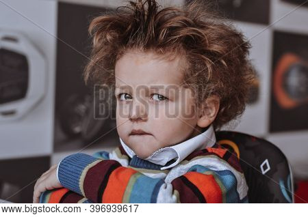 Funny Curly-haired Child Boy Expresses Funny Emotions Surprise Charismatic In A Sweater Black-and-wh