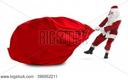 Santa Claus Puling Enormous Red Bag Full Of Christmas Gifts On White Background