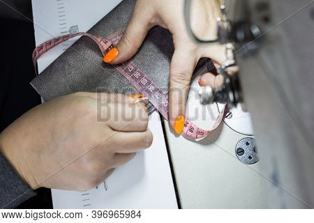 The Seamstresss Hands Measure The Length With A Centimeter. Place Of Work. View From Above. Creative