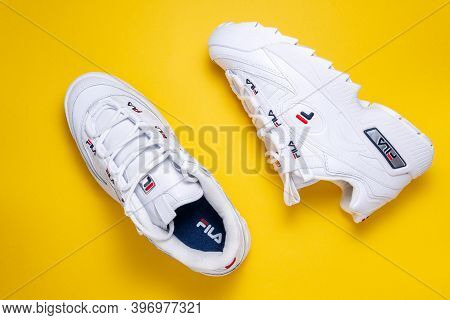 Tyumen, Russia-november 27, 2020: Fila White Women Sneakers On A Colored Yellow Background, Fila Is 