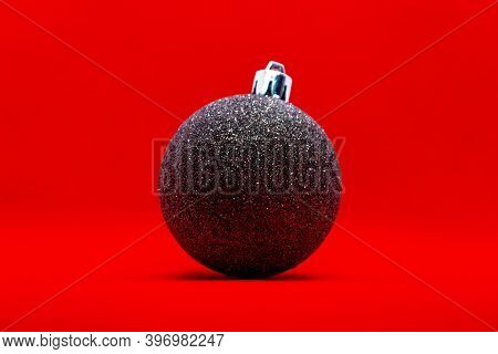 Christmas Ball With Glitter Over Red Background