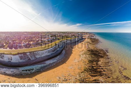 Drone aerial view of the beach and white cliffs on sunny day, Margate, England, UK