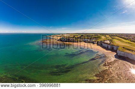 Drone aerial view of the beach and white cliffs on sunny day, Margate, England, UK