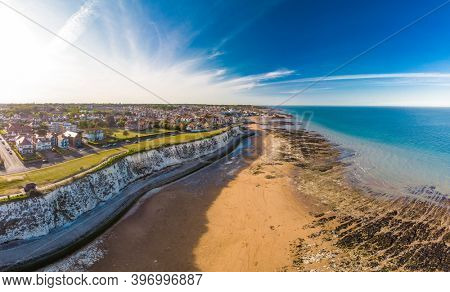 Drone aerial view of the beach and white cliffs on sunny day, Margate, England, UK