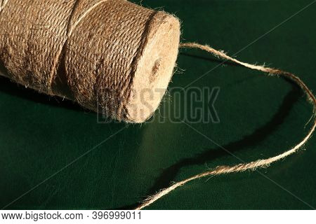 String For Wrapping Gifts In Babine On A Dark Emerald Background In The Sun, Space For Text