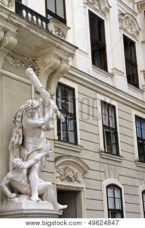VIENNA, AUSTRIA - AUGUST 2012 : Michaelertrakt, Statue of Hercules and Busiris at the gate of the Michaelertrakt, wing of the Imperial palace at Michaelerplatz on August 8, 2012 in Vienna, Austria. 