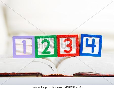 Alphabet block with 1234 on book