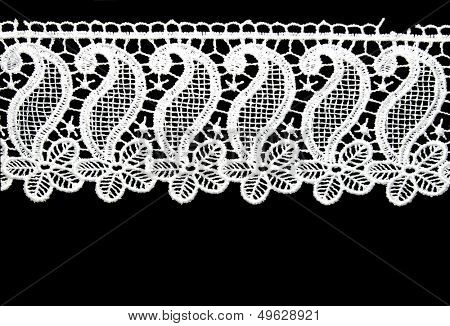 white lace border isolated over black - texture for scrapbook