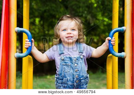 Happy Smiling Child  Playing In A  Playground Area