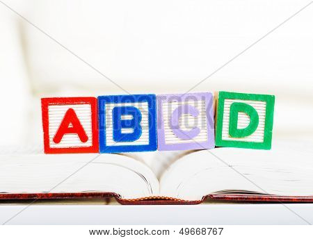 Alphabet block with ABCD on book