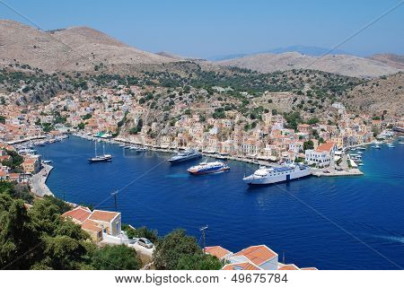 SYMI, GREECE - JUNE 19: Looking down onto boats moored in Yialos harbour on June 19, 2011 on Symi island, Greece. Yialos is a popular destination for day trippers from Rhodes island.