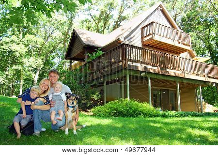Happy Family And Dog By House