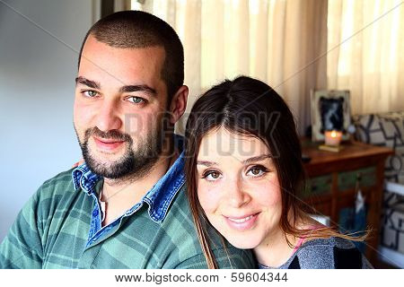 Portrait Of Young Married Turkish Couple Smiling At Home