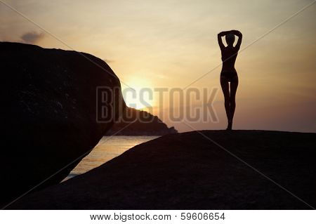 Figure of a girl in contre at sunset on the sea