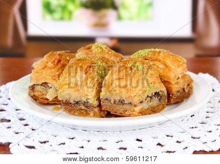 Sweet baklava on plate on table in room