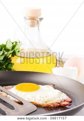 Fried eggs on a frying pan with olive oil