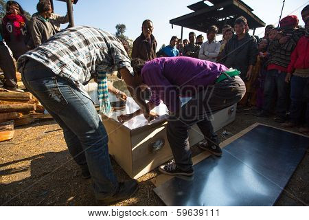 KATHMANDU, NEPAL - DEC 3, 2013: Unidentified local people during the cremation ceremony along the holy Bagmati River in Bhasmeshvar Ghat at Pashupatinath temple in Kathmandu.