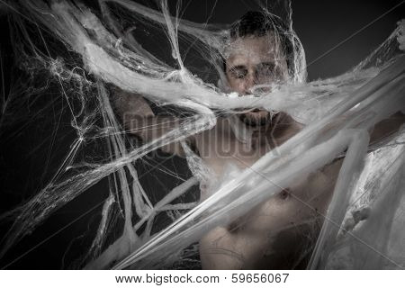 Geometry.man tangled in huge white spider web