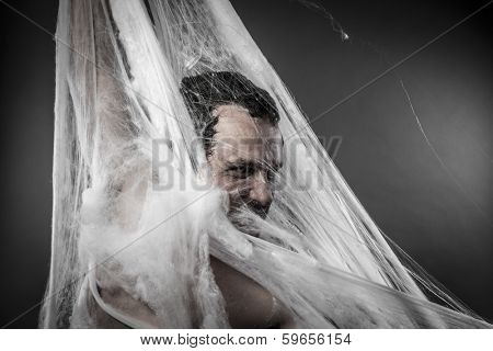 Night.man tangled in huge white spider web