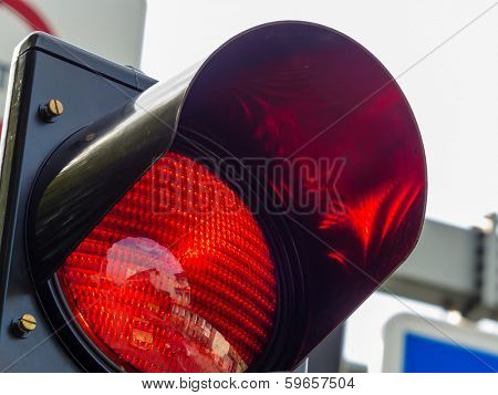 at a traffic light, the red light is lit. symbolic photo for holding