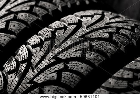  winter car tyre on a black background