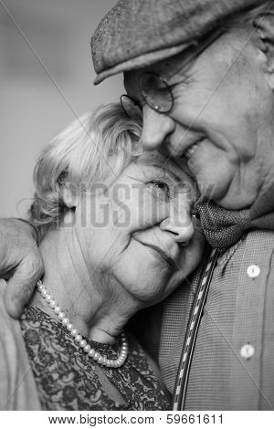 Black-and-white image of senior couple in smart clothes