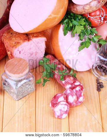Lot of different sausages on wooden table close-up