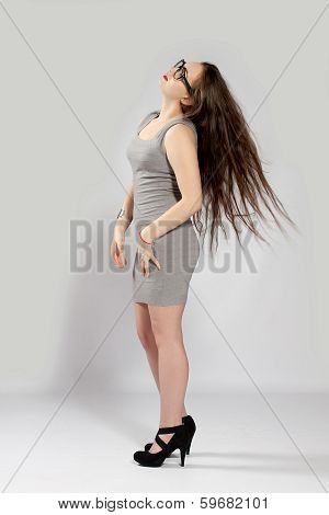 Long-haired Teenager Girl In Gray Minis In Cool Glasses And Black High Heels