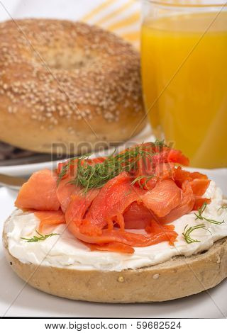 Delicious freshly baked Everything Bagel with cream cheese, lox (also known as salmon) and dill served with fresh orange juice