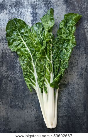 Silverbeet on dark slate.  Overhead view.