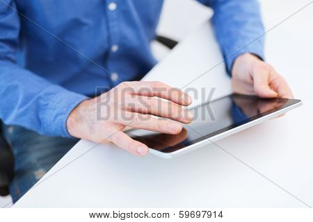technology and internet concept - close up of male hands working with tablet pc computer