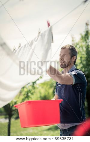 Young man hanging up laundry
