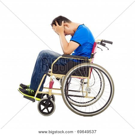 Upset Man Sitting On A Wheelchair