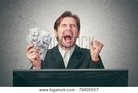 Happy Businessman With Money In Hand  And Computer