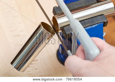 Mechanic Saws Chrome Plated Drain Pipe Close Up
