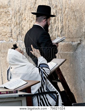 JERUSALEM, ISRAEL - OCTOBER 31, 2014: Two orthodox Jewish men praying at the Western Wall.