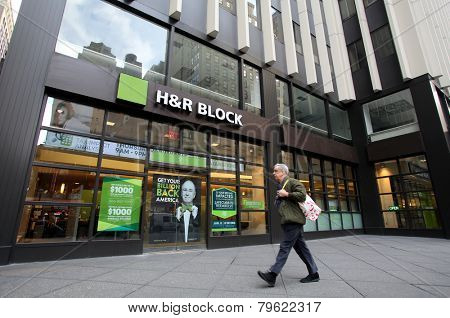 NEW YORK CITY - MONDAY, DEC. 29, 2014: Pedestrians walk past an office of H&R Block. H&R Block is a tax preparation company in the United States