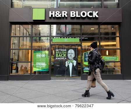 NEW YORK CITY - MONDAY, DEC. 29, 2014: Pedestrians walk past an office of H&R Block. H&R Block is a tax preparation company in the United States