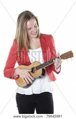 Teenage Girl Plays Ukelele In Studio Against White Background