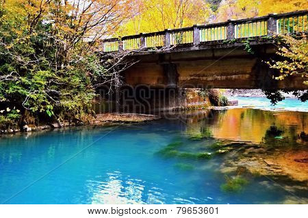 The old bridge over the blue mountain lake