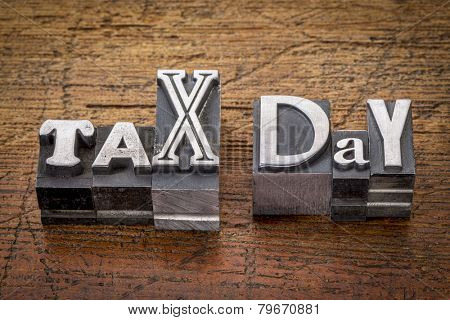 tax day - financial concept - words in mixed vintage metal type printing blocks over grunge wood