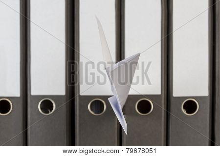 Paper Plane Stuck Between Folders