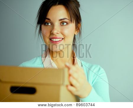 Portrait of a sick woman blowing her nose while sitting on the sofa