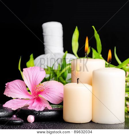 Spa Setting Of Hibiscus Flower, Twig Bamboo, Thai Herbal Compress Balls, Beads And Candles On Zen Ba