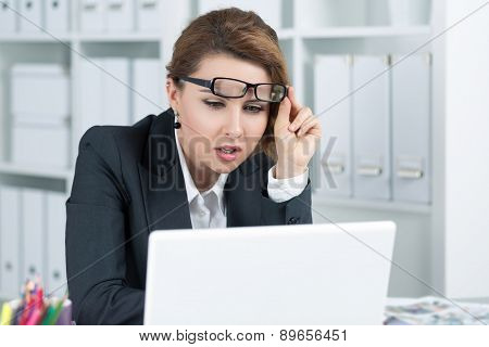 Young Business Woman Looking Intently At Laptop
