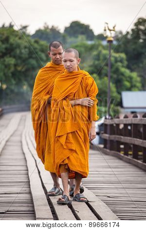 Sangkhlaburi, Kanchanaburi, Thailand - January  12, 2015: Buddhist monks walk on Bamboo Bridge the Sangkhlaburi River, Kanchanaburi, Thailand.