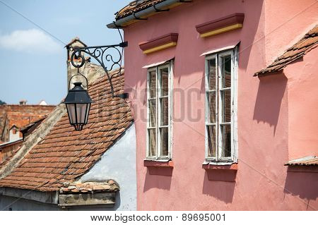 Pink Facade With White Windows And Street Lamp